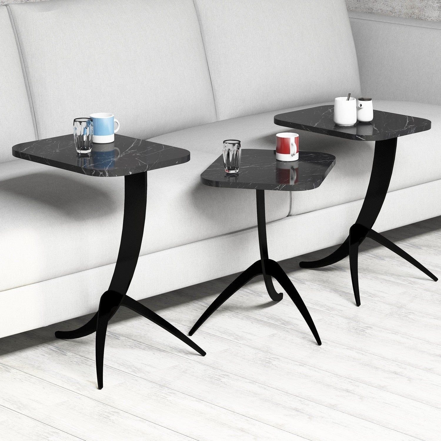 Set de 3 măsuțe de cafea negre, elegante, alături de o canapea într-un living modern – primabucata